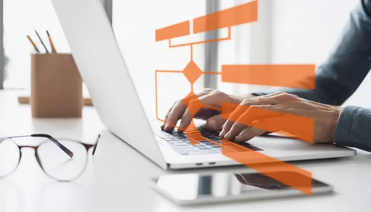 Process visualization on laptop Hands using a laptop with an overlaid process diagram