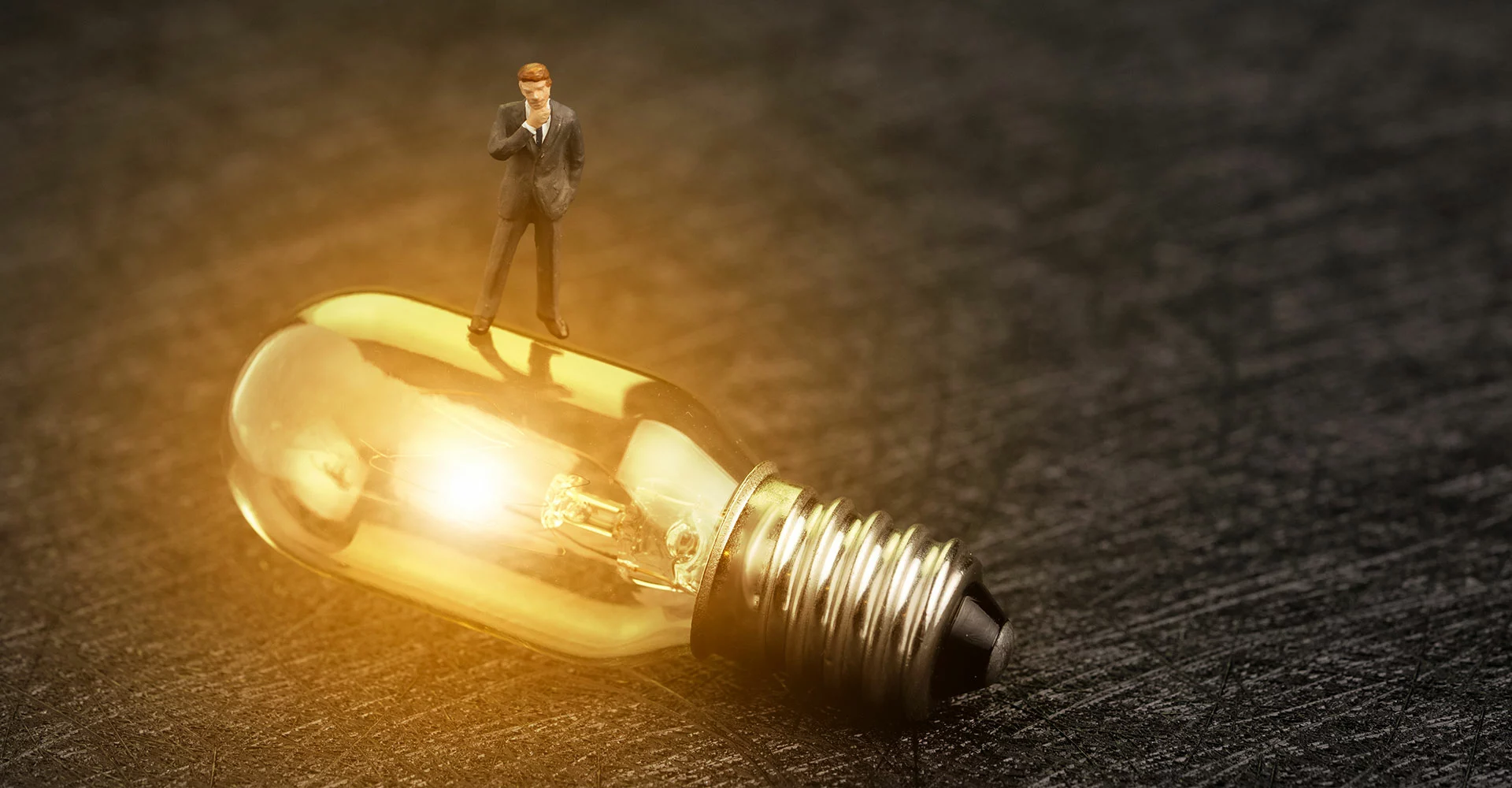 Glowing light bulb with figure on it