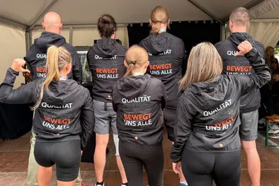 Group photo from behind of Babtec employees wearing running shirts
