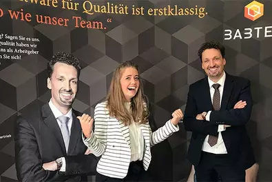 HR on Tour - Career Fair@HTW Dresden Alina Ziehn and Babtec employees standing in front of the Babtec banner at the Babtec stand at the career fair