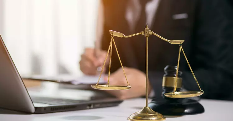 Update on Supply Chain Law Scales, laptop and judge's hammer on a desk