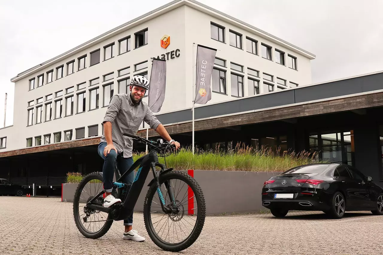 A benefit at Babtec: the job bike Babtec employee on his job bike in front of the company building in Wuppertal